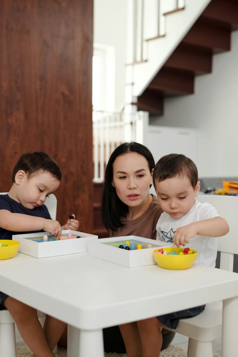 A mother and her two children engage in creative play indoors, fostering learning and bonding.