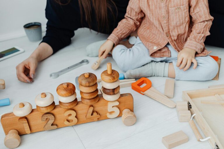 Young child playing with educational wooden toys indoors. Promotes creativity and learning.
